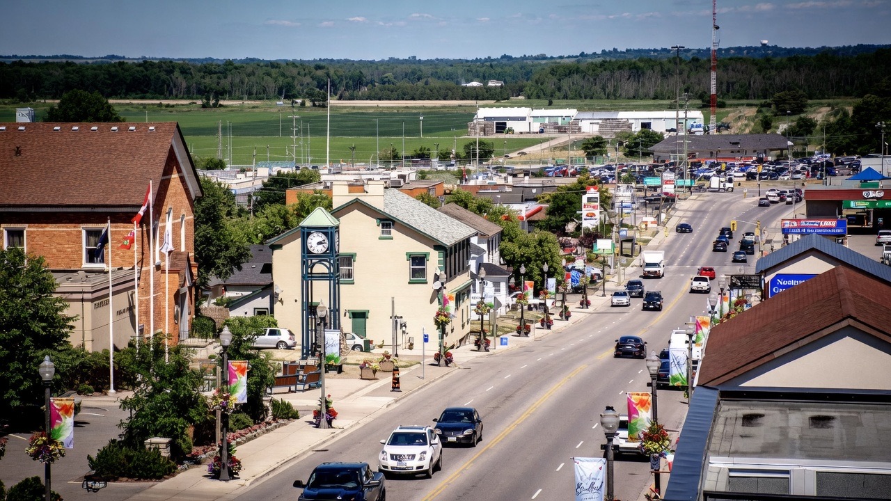 Elevated view of downtown Bradford, Ontario with clock tower and Holland Marsh fields beyond